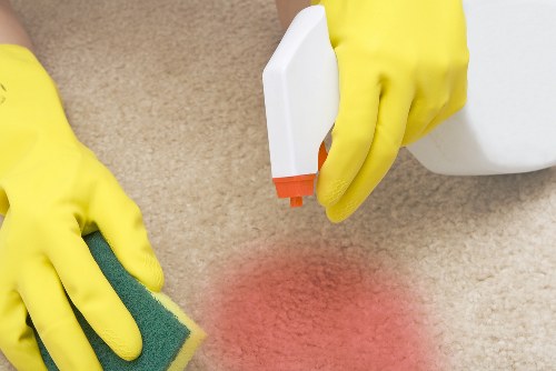 Professional rug cleaning in Addington removing dirt from a living room rug