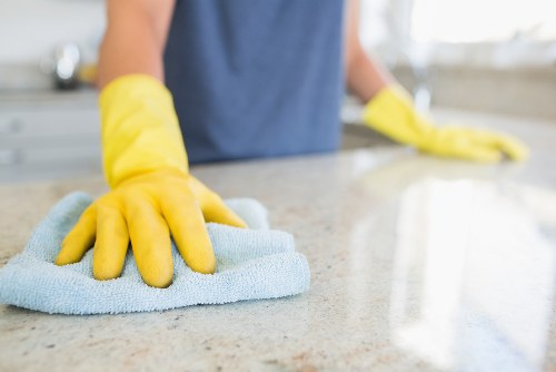 Technician using protective gloves and mask during carpet cleaning